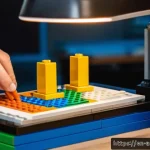 Home 21 레고 브릭 조립 시 실수 대처법 - A well-lit, organized LEGO building workspace showing a person’s hands carefully assembling colorful...